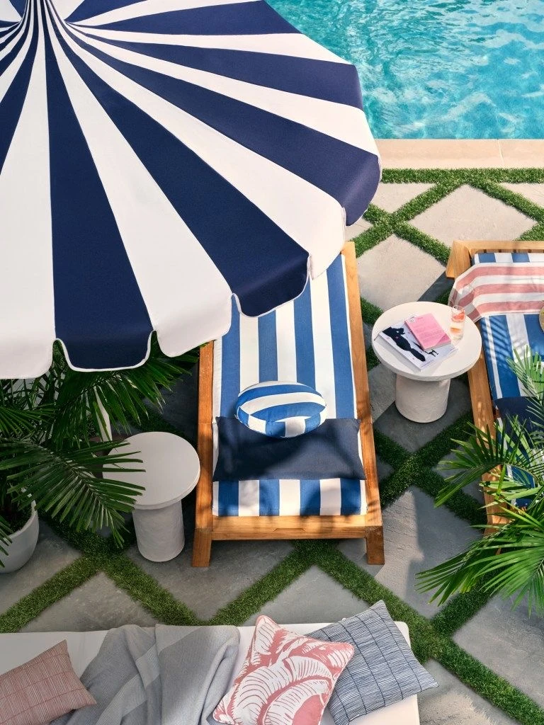 Striped cabana umbrella beside a clean Dallas, Texas pool